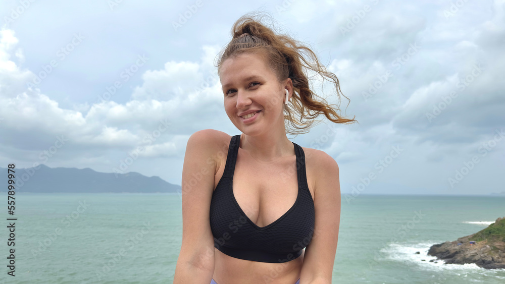 Portrait of beautiful girl, young happy woman at sea, ocean background, enjoying summer sunny day, vacation on mountain, smiling in tropical country, have fun Portrait of beautiful girl, young happy woman at sea, ocean background, enjoying summer sunny day, vacation on mountain, smiling in tropical country, have fun