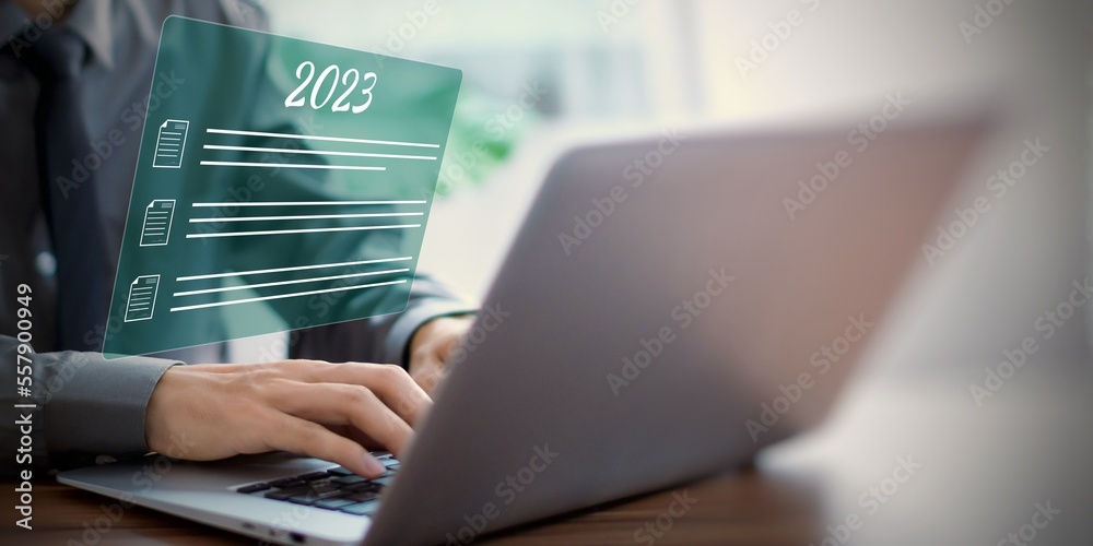 Businessman laptop using with concept of 2023 document file upload in internet. Businessman laptop using with concept of 2023 document file upload in internet.