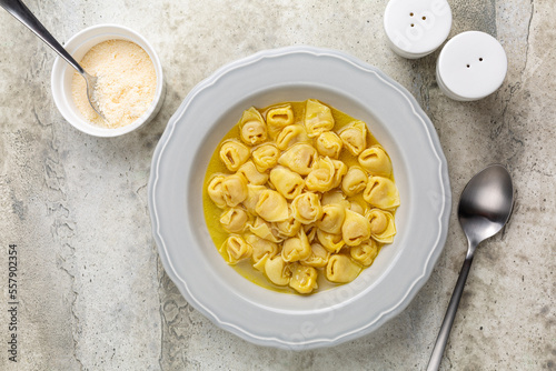 Tortellini in beef and chicken broth. Egg pasta originally from the Italian region of Emilia, Bologna. Stuffed with a mix of meat, prosciutto, mortadella, hard cheese, egg and served in capon broth. photo