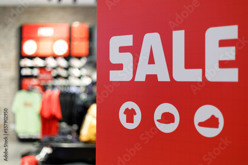 Sale text on a display board stand inside a popular clothing store during year end season sale