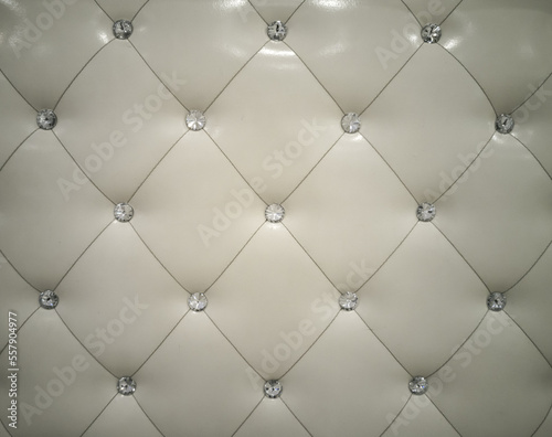 Wall or furniture surface background, cream colored leather with rhombus and diamonds shiny.