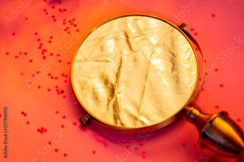 Golden mirror on pink background 