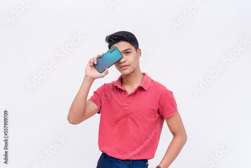 A handsome man showing off his new mobile phone covering his eye. Cellphone app advertisement layout.