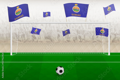 Kansas football team fans with flags of Kansas cheering on stadium, penalty kick concept in a soccer match.