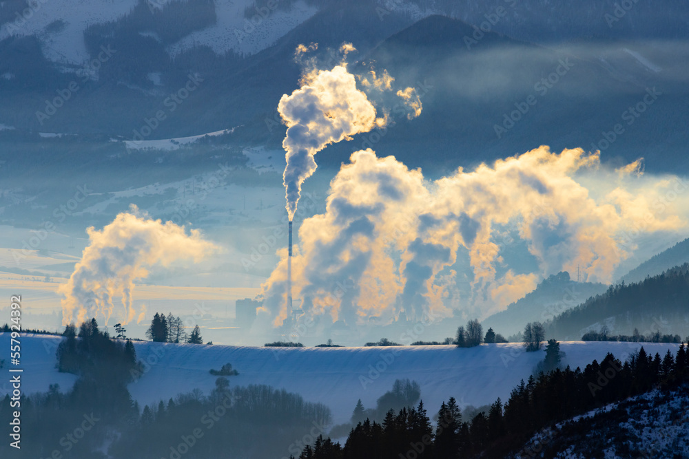 environmental burden in winter landscape, smoked chimneys