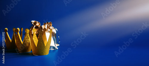 Happy Epiphany Day, Three Kings Day greeting card with three gold crowns and gifts on blue background. Concept for Dia de Reyes Magos day, three Wise Men, Epiphany Christian feast day