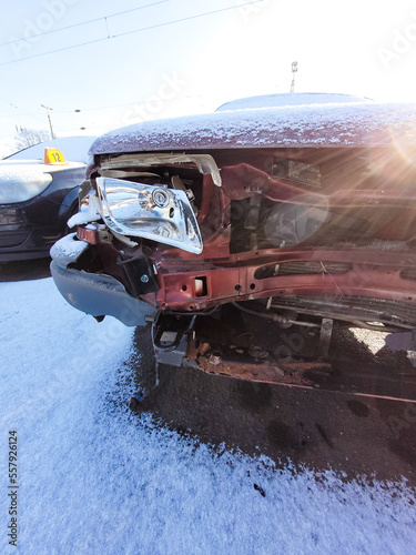 Front of an accident car in sunlight and with snow © Claudia Evans 