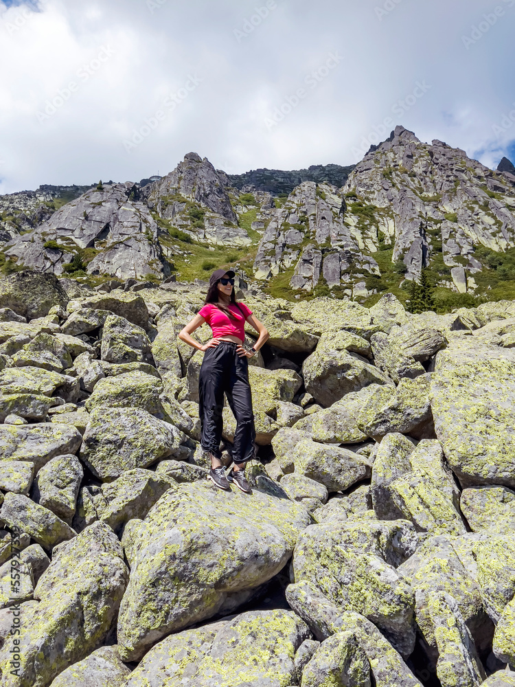Woman standing on a rocks in the mountain  .Traveling in the summer nature in Bulgaria  