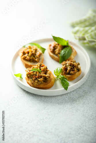 Crostini with olive tapenade and basil