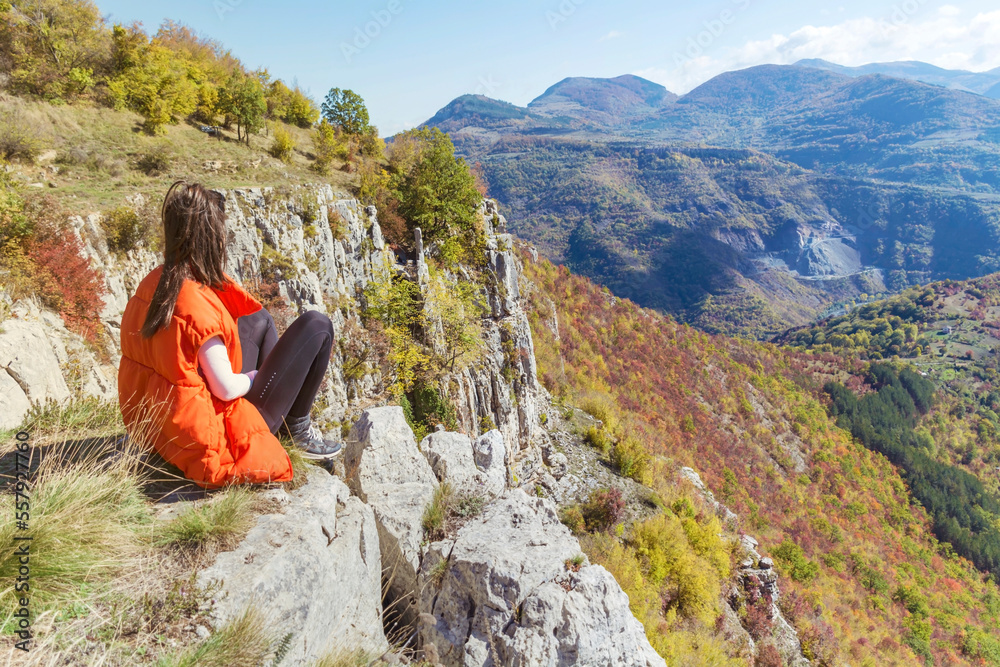 Traveler Woman sitting on a rocks  in the autumn  mountain . Balkan mountains,  ,Bulgaria