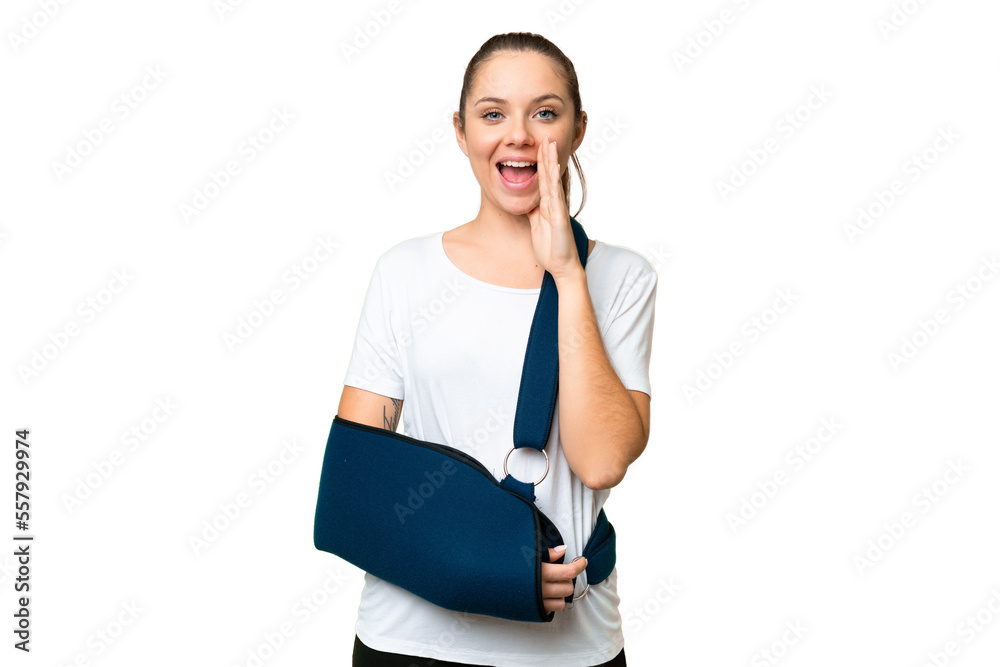 Young blonde woman with broken arm and wearing a sling over isolated chroma key background shouting with mouth wide open Young blonde woman with broken arm and wearing a sling over isolated chroma key background shouting with mouth wide open