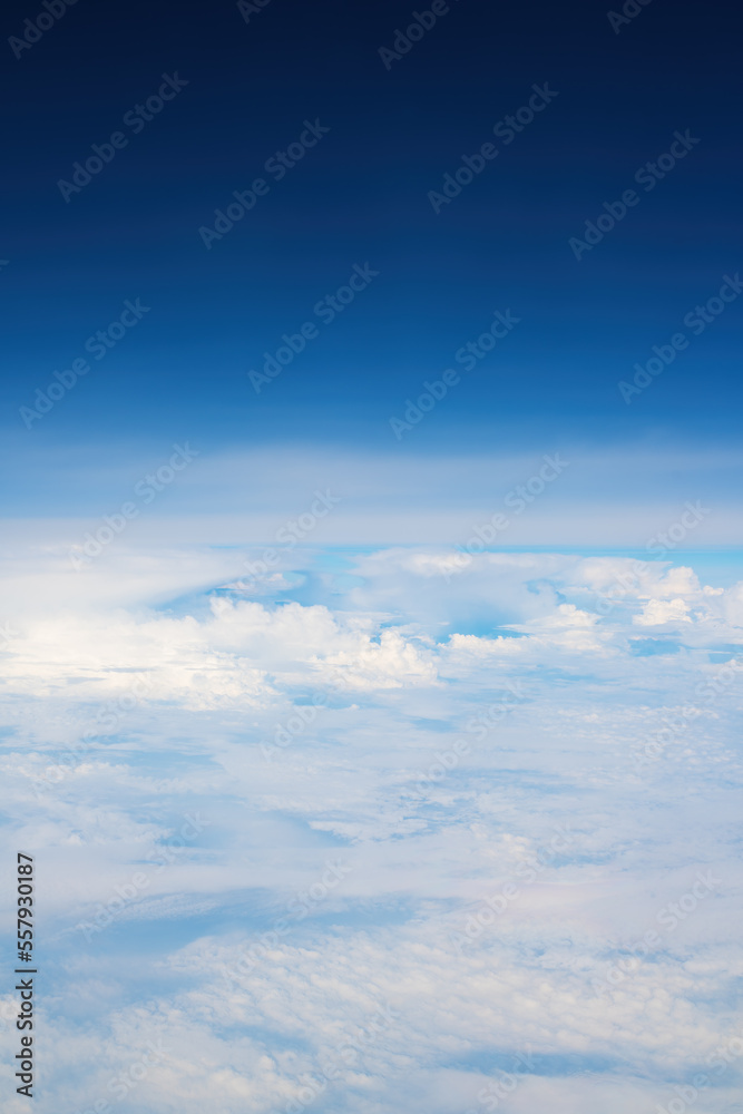 White cumulus clouds seen from the passenger airplane on sunny summer day, aerial view White cumulus clouds seen from the passenger airplane on sunny summer day, aerial view