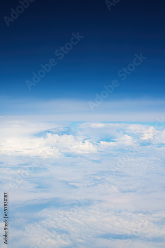 Fototapeta Naklejka Na Ścianę i Meble -  White cumulus clouds seen from the passenger airplane on sunny summer day, aerial view