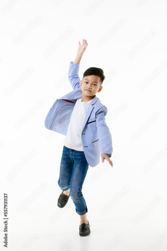 A 10-year-old Asian boy in a casual jacket is jumping smartly and happily looking at the camera against a white isolate background.
