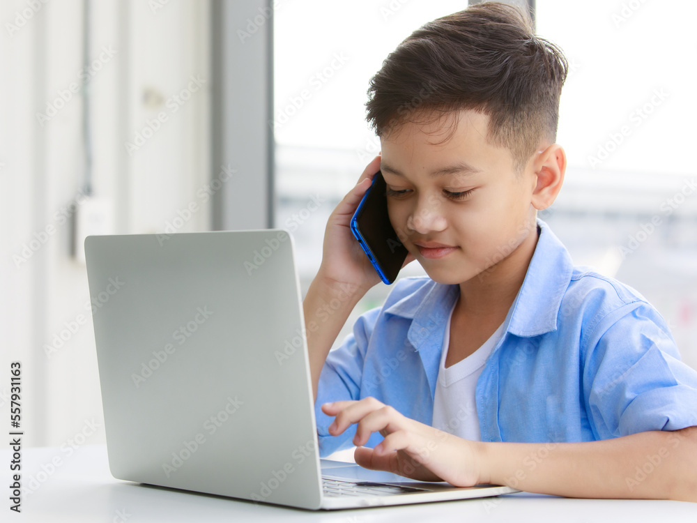 Asian boy holding a smartphone and communicating Asian boy holding a smartphone and communicating