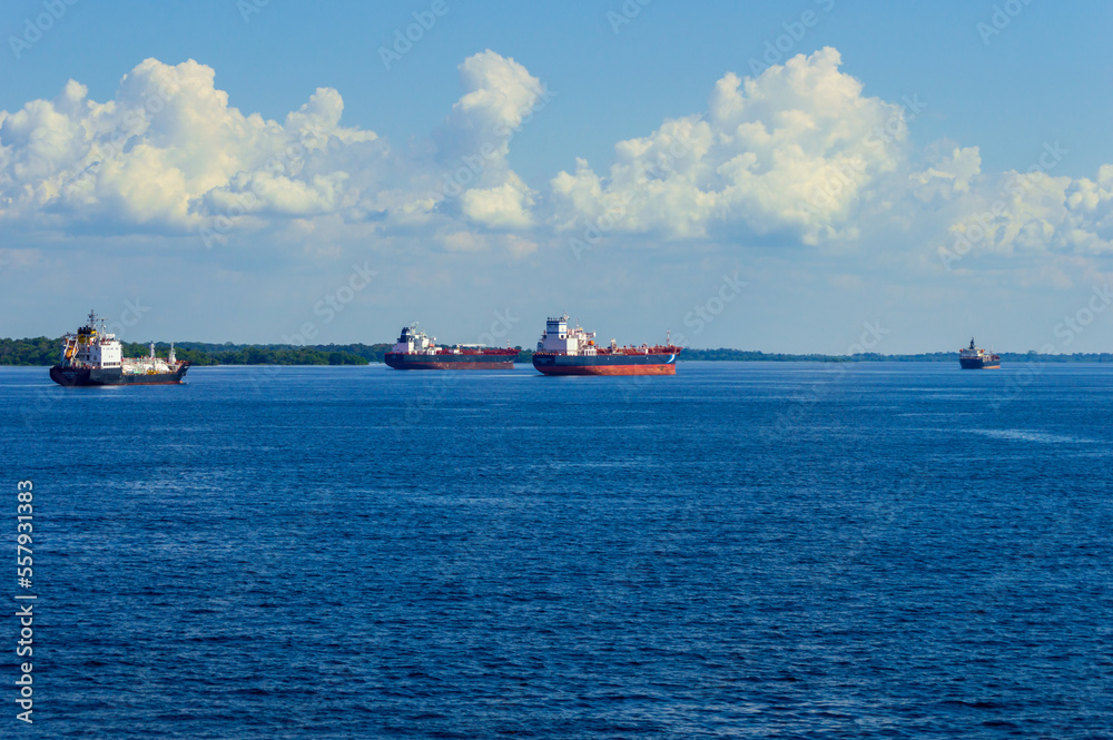 Cargo ships travelling along the Amazonas river in Brazil along the route between manaus and Belem