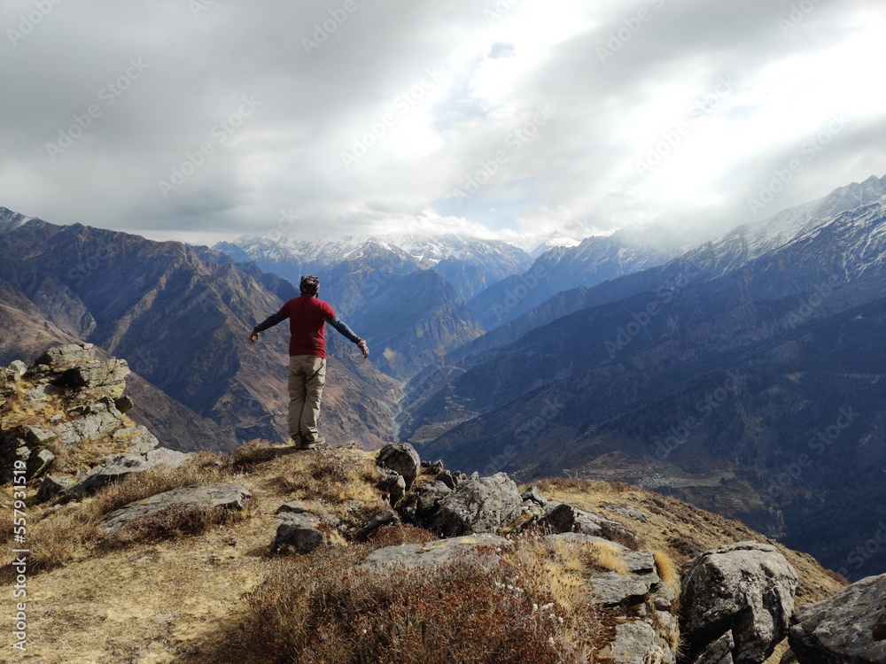 hiker on top of mountain View from the top of the mountain in Himalayas... Trekking Adventure.