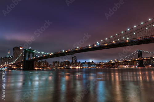 Brooklyn Bridge and Manhattan Bridge at Night. Long Exposure. New York. NYC  USA. Lights Reflection on Water.at Night.