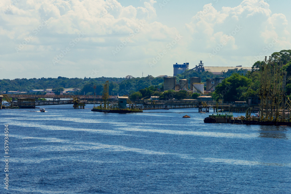 Industrial site on the river banks of Rio Amazonas in Brazil surrounded by the green rainforest