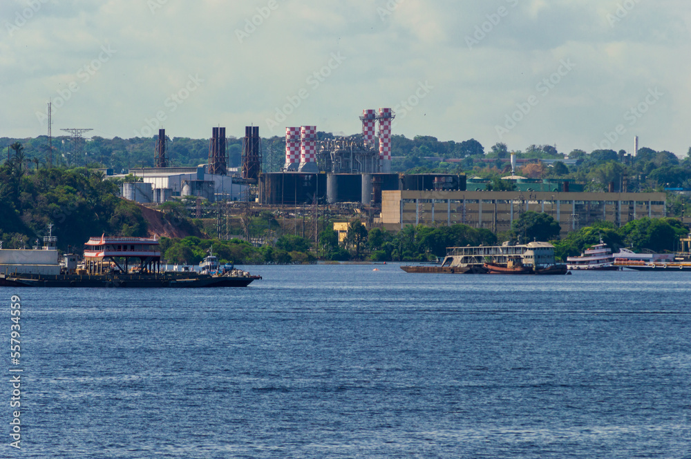 Industrial site on the river banks of Rio Amazonas in Brazil surrounded by the green rainforest