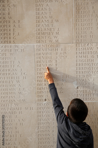 Boy pointing to a name in the Thiepval Memorial to the Missing of the Somme photo
