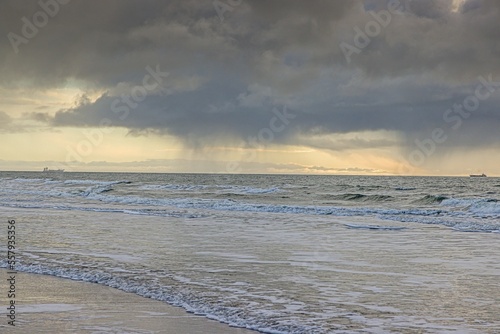 Picture of transport ship on stormy sea photographed from a beach