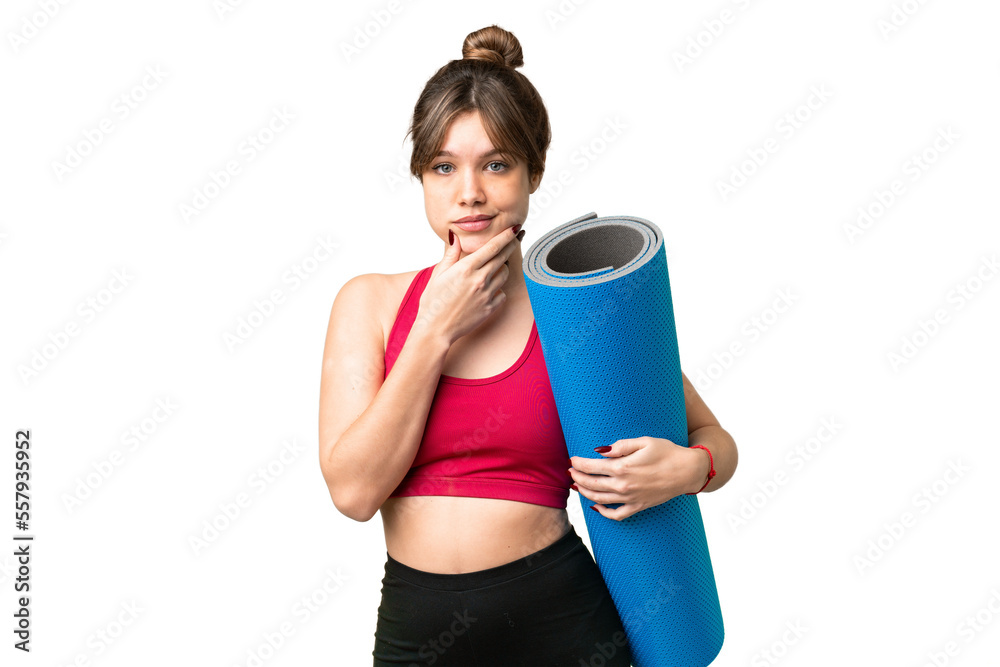 Young sport girl going to yoga classes while holding a mat over isolated chroma key background thinking Young sport girl going to yoga classes while holding a mat over isolated chroma key background thinking