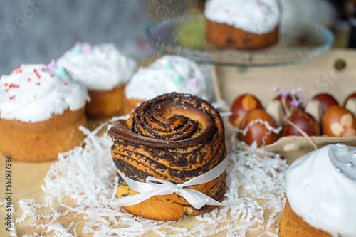 Festive poppy seed kraffin is on the table with Easter eggs and pastries photo