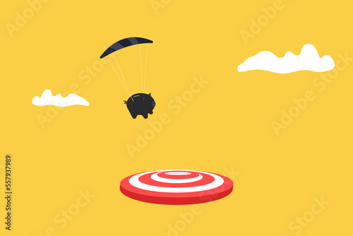 piggy bank with parachute landing on the target. concept of goal, opportunity and success