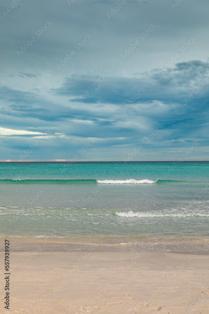 San Teodoro sand beach with turquoise sea water in Sadinia Italy, clouds in the sky during summer