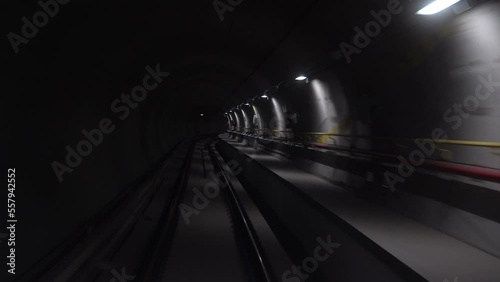 subway train enters underground tunnel at rapid fast speed - Europe, Italy , Milan 2023 - the new line 4 underground to Linate airpor - start a journey adventure  photo