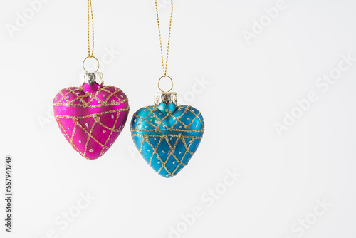 Companionship love heart pendants suspended and isolated over a white background