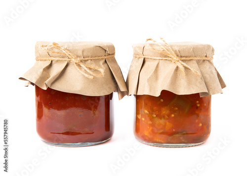 Canned tomato sauce, prepared at home and eggplant salad in glass jars isolated on white background. Pickled jars.