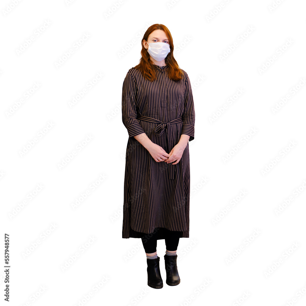 A sad woman in a medical mask stands in an empty hospital corridor, isolated on a white background. Woman patient in dark clothing in the hospital room, concept