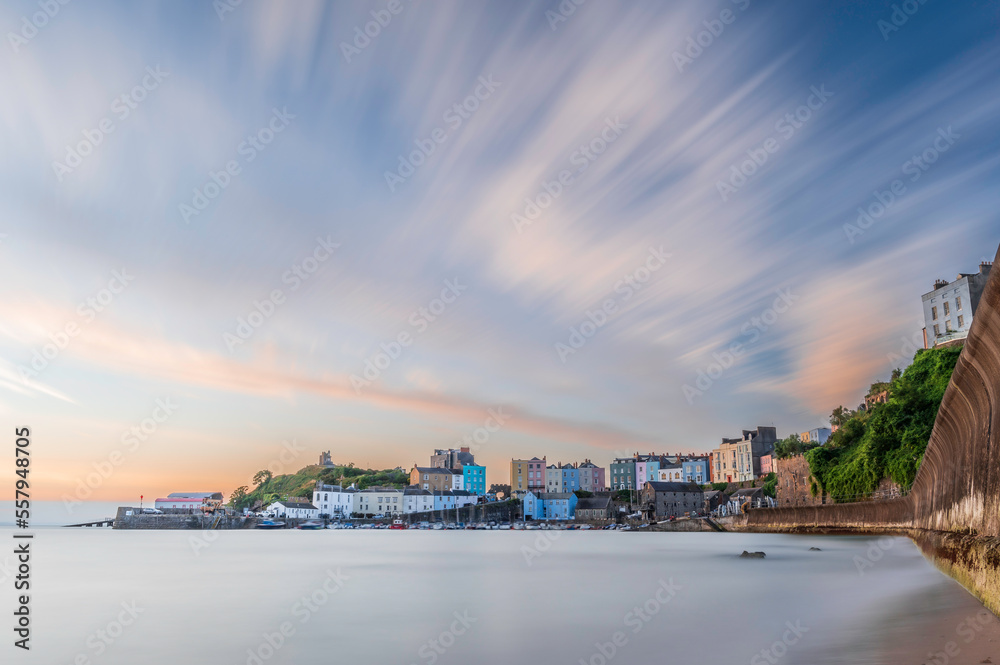 Sunrise over Tenby's harbour on a calm summer's morning. Tenby is a holiday destination on the south coast of Wales, UK
