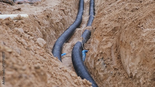 Plastic Corrugated Drainage Pipe Laid in Trench Ditch on Construction Site photo