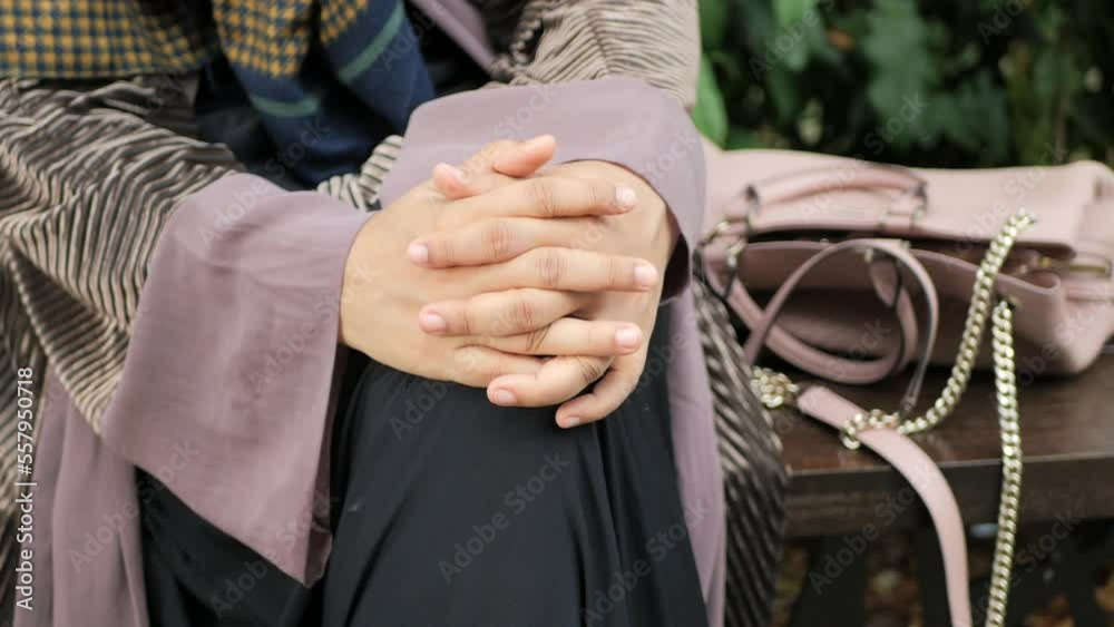 thoughtful muslim women sitting on park thoughtful muslim women sitting on park