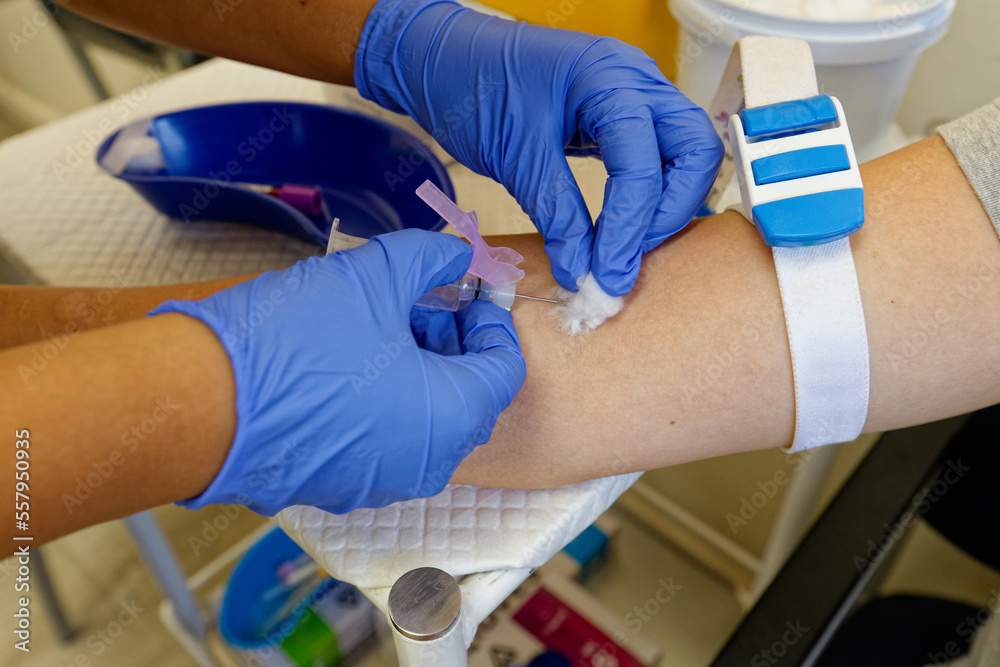 Blood drawn from a young, female patient, showing her arm and the