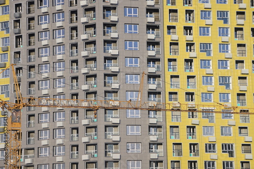 urban modern landscape and multi-colored new buildings residential buildings, windows, air conditioners, facades in winter, Biryulovo, Moscow, January 2023.