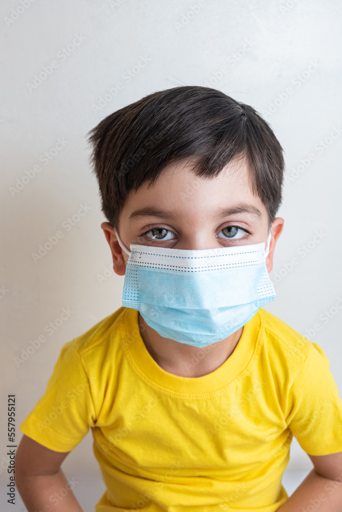 Cute and happy boy with yellow t-shirt - With surgical mask