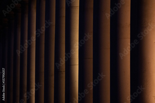 Light rolls around regal columns at night, London, England - Tight 
