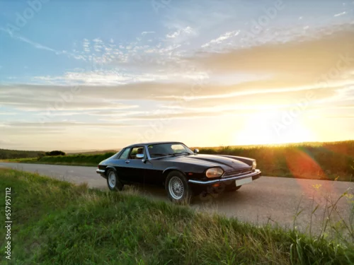Obraz  z motywem classic car in the field road at sunset