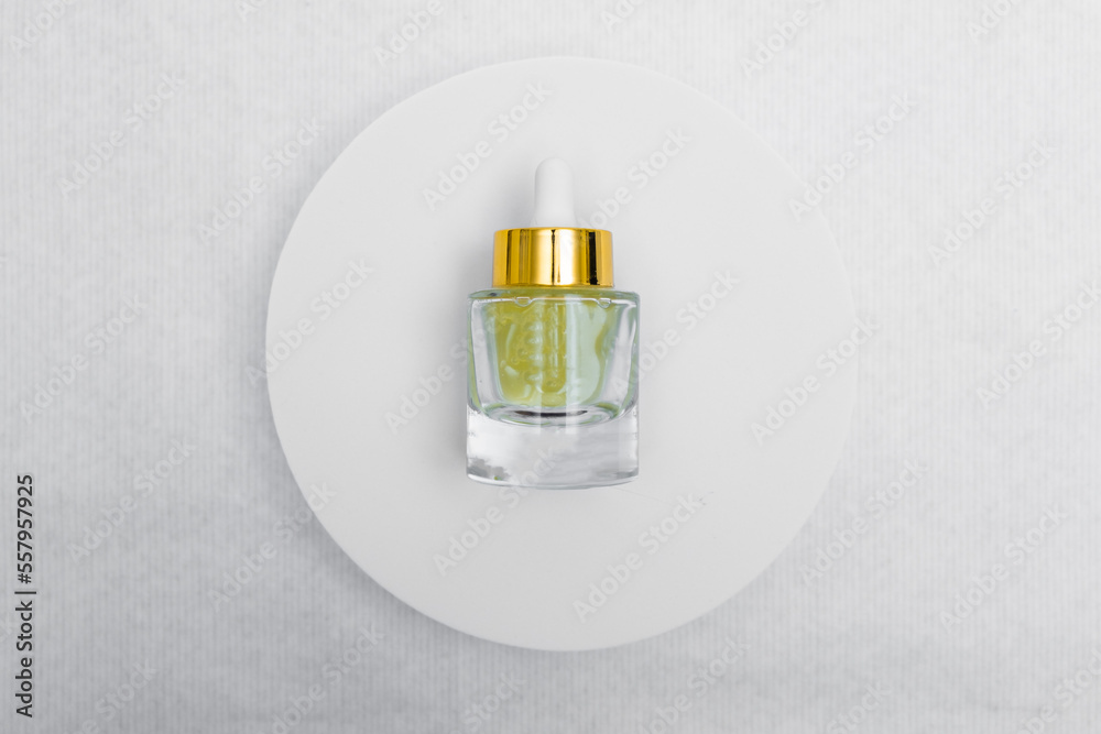 Trendy Beauty concept of Facial Serums, Natural Essential Oil in cosmetic bottles with dropper and bright sunligth shadow on white background. Trendy Beauty concept of Facial Serums, Natural Essential Oil in cosmetic bottles with dropper and bright sunligth shadow on white background.