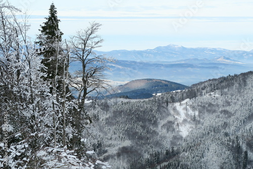 in ski area skalka above village of kremnica with snow and forest in the mountains in slovakia with sights and locations with sunshine in winter photo