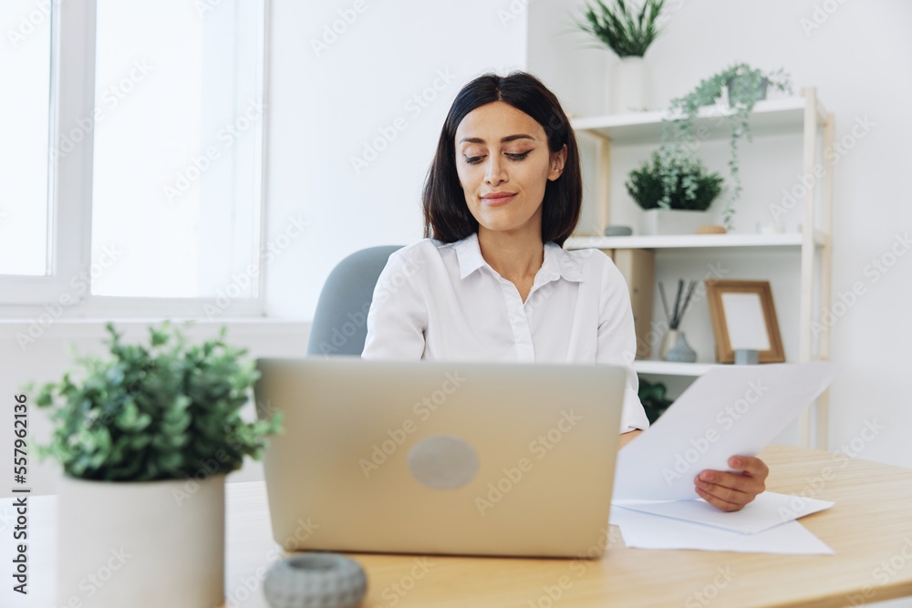 Woman business working at her laptop at home in her office, freelance employee in business, happiness of working online, technology in business Woman business working at her laptop at home in her office, freelance employee in business, happiness of working online, technology in business