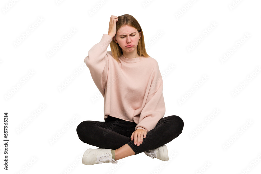 Young caucasian woman sitting on the floor cutout isolated Young caucasian woman sitting on the floor cutout isolated