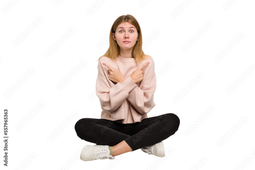 Young caucasian woman sitting on the floor cutout isolated Young caucasian woman sitting on the floor cutout isolated