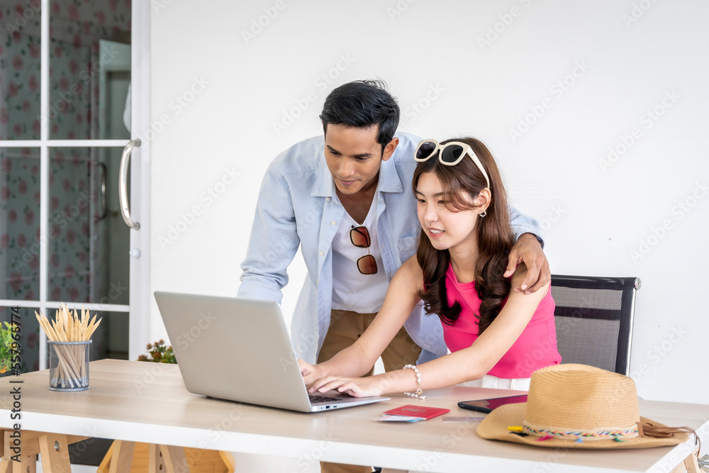 Asian couples are preparing to travel together both domestically and internationally. Have a good travel plan through the Internet. Both of them are happy and excited about going on a trip together. Asian couples are preparing to travel together both domestically and internationally. Have a good travel plan through the Internet. Both of them are happy and excited about going on a trip together.