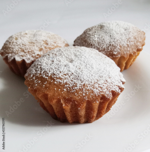 homemade cupcakes sprinkled with powdered sugar