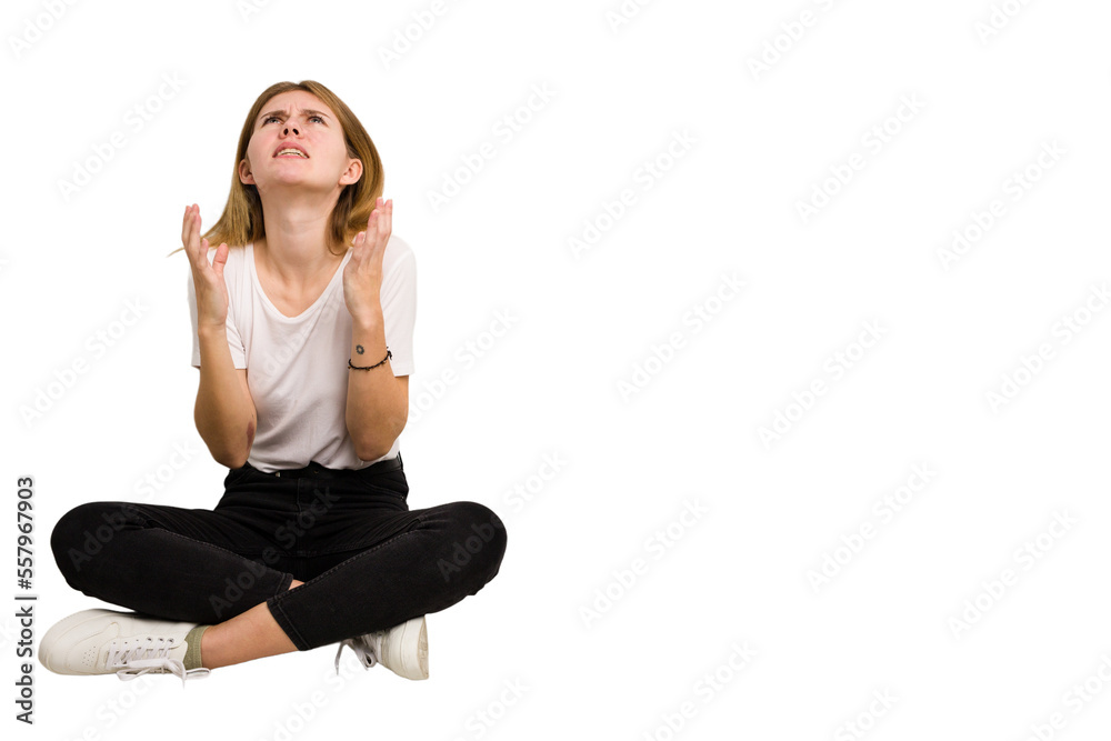 Young caucasian woman sitting on the floor cutout isolated Young caucasian woman sitting on the floor cutout isolated